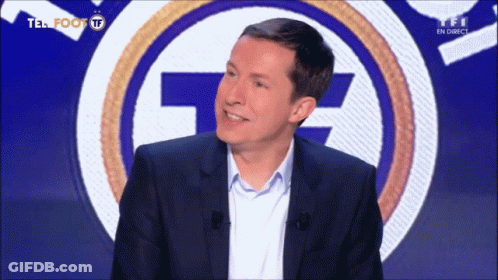 A Man Stands In Front Of A Tf Logo GIF