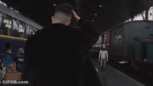 A Man Stands In Front Of A Train That Has The Word Canal On It GIF