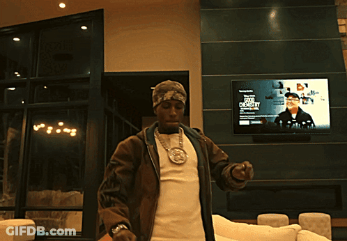 A Man Stands In Front Of A TV Screen That Says ' A Few Dollars ' On It GIF