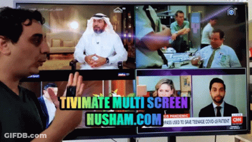 A Man Stands In Front Of A Tv Screen That Says Tivimate Multi Screen Husham.com On It GIF
