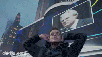 A Man Stands In Front Of A Usa Sign GIF