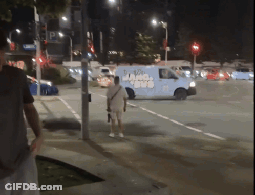 A Man Stands In Front Of A Van That Has The Word Ice Cream On The Side GIF