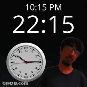 A Man Stands In Front Of A Wall Clock That Says 10:15 Pm GIF