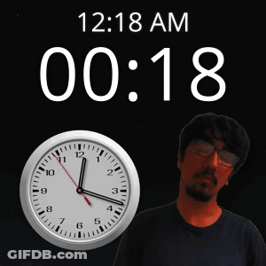 A Man Stands In Front Of A Wall Clock That Says 12:18 Am GIF