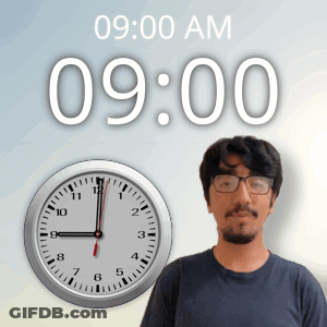 A Man Stands In Front Of A Wall Clock That Says 9:00 Am GIF