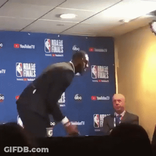 Man In Front Of NBA Finals Wall GIF