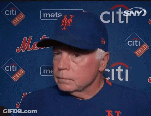 A Man Stands In Front Of A Wall With Citi Field Logos GIF