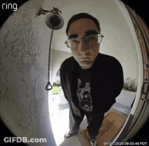 A Man Stands In Front Of A Welcome Mat GIF
