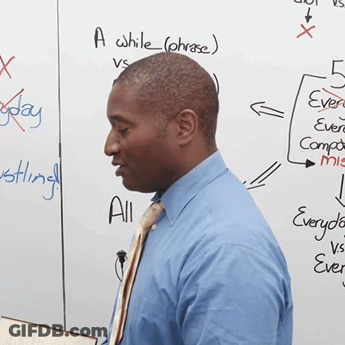 A Man Stands In Front Of A White Board That Says A While ( Phrase ) On It GIF