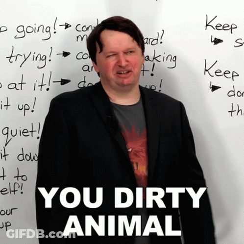A Man Stands In Front Of A White Board That Says " You Dirty Animal " On It GIF