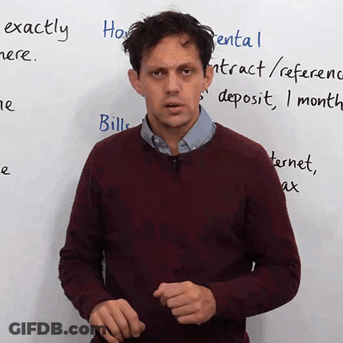 A Man Stands In Front Of A White Board With The Words Exactly Written On It GIF