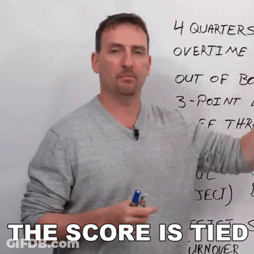 A Man Stands In Front Of A White Board With The Words The Score Is Tied On It GIF