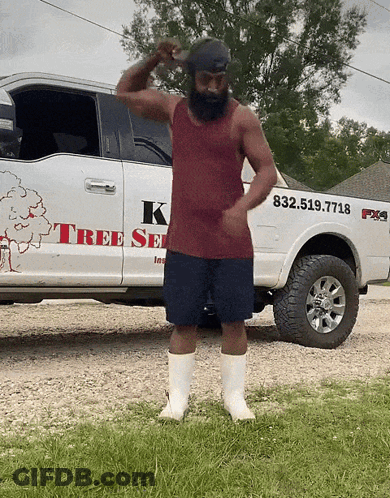 A Man Stands In Front Of A White Truck That Says K Tree Service GIF