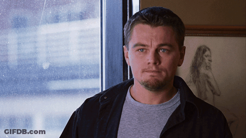 A Man Stands In Front Of A Window With A Drawing Of A Woman Behind Him GIF