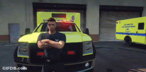 A Man Stands In Front Of An Ambulance That Says ' Los Santos Fire Department ' GIF