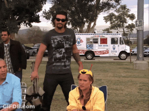 A Man Stands In Front Of An Ice Cream Truck That Says Ice Cream GIF