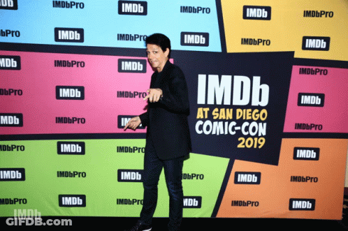 A Man Stands In Front Of An Imdb At San Diego Comic Con 2019 Banner GIF