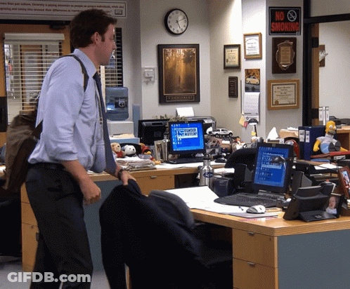 A Man Stands In Front Of An Office With A No Smoking Sign GIF