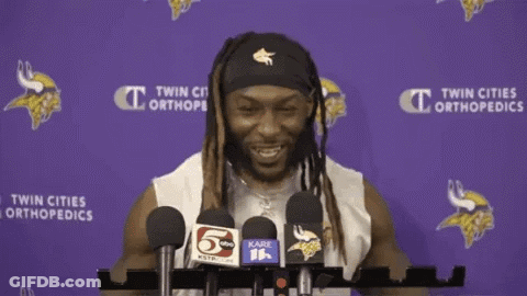 A Man Stands In Front Of Microphones With His Arms Outstretched GIF