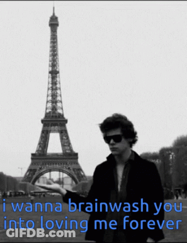 A Man Stands In Front Of The Eiffel Tower With A Caption That Says I Wanna Brainwash You Into Loving Me Forever GIF
