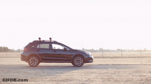 A Man Stands Next To A Black Suv With A Camera On The Roof GIF