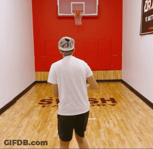 A Man Stands On A Basketball Court That Says Slash GIF