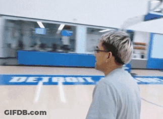 A Man Stands On A Basketball Court With The Word Detroit On It GIF