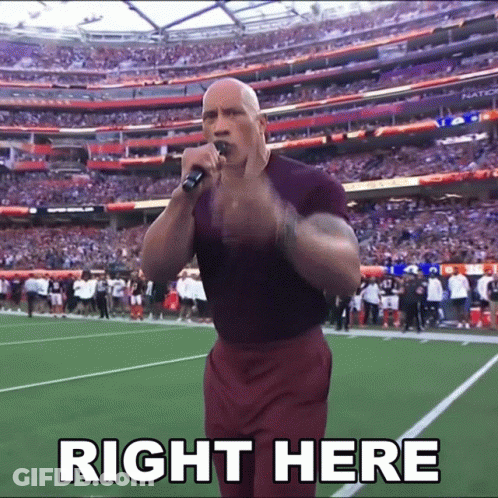 A Man Stands On A Football Field Holding A Microphone With The Words Right Here Above Him GIF
