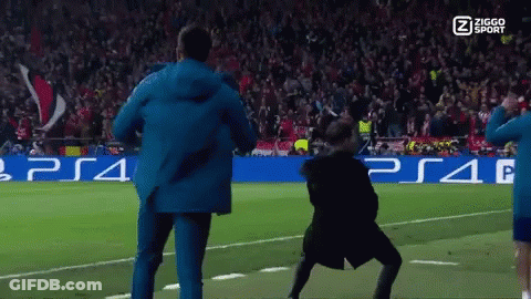 A Man Stands On A Soccer Field In Front Of A Ps4 Advertisement GIF