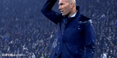 A Man Stands On A Soccer Field In Front Of A Uefa Champions League Advertisement GIF