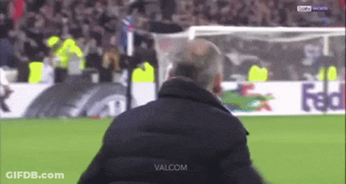 A Man Stands On A Soccer Field With The Word Valcom On The Bottom Right GIF