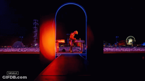 A Man Stands On A Stage In Front Of A Crowd With A Sign That Says Cancelled GIF