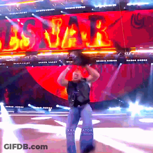 A Man Stands On A Stage In Front Of A Sign That Says ' Us Var ' GIF