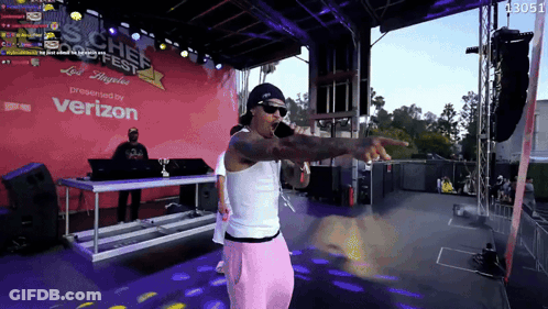 A Man Stands On A Stage In Front Of A Sign That Says ' Verizon ' GIF