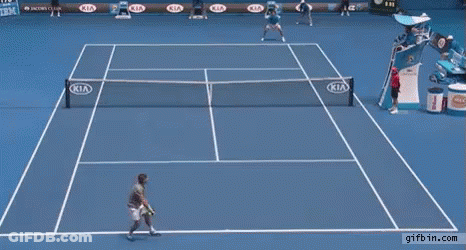A Man Stands On A Tennis Court With Kia Advertisements On The Walls GIF
