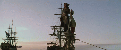 A Man Stands On The Mast Of A Ship In The Middle Of The Ocean GIF