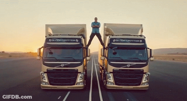 A Man Stands On The Roof Of A Volvo Truck GIF