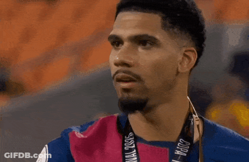 A Man Sticking His Tongue Out While Wearing A Shirt With A Lion On It GIF
