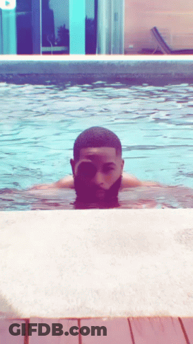 A Man Swimming In A Pool With His Eyes Closed GIF