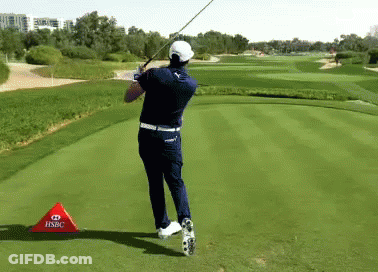 A Man Swinging A Golf Club On A Golf Course With A Hsbc Sign In Front Of Him GIF