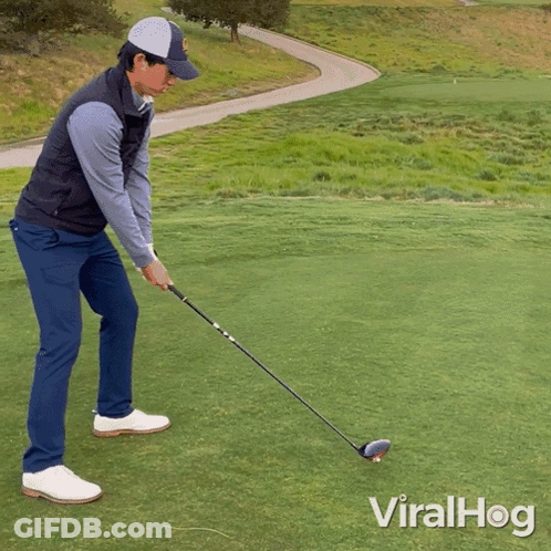 A Man Swinging A Golf Club On A Golf Course With Viralhog Written On The Bottom Right GIF