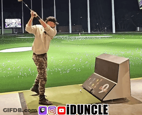 A Man Swings A Golf Club On A Driving Range With A Twitch Logo In The Upper Right Corner GIF