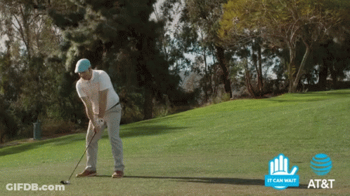 A Man Swings A Golf Club On A Golf Course With An At & T Logo In The Background GIF