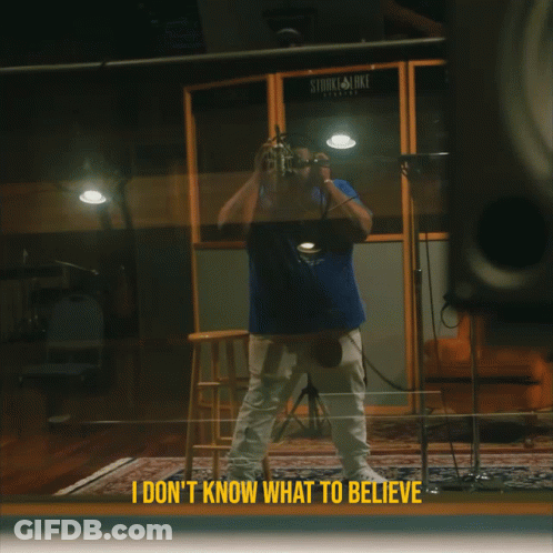 A Man Taking A Picture In Front Of A Stark & Luke Recording Studio GIF