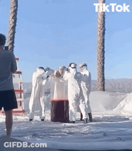A Man Taking A Picture Of A Group Of People With The Word Tik Tok On The Bottom Right GIF