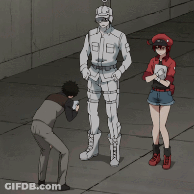 A Man Taking A Picture Of A Man In A White Uniform And A Woman In A Red Uniform GIF