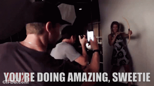 A Man Taking A Picture Of A Woman With The Words You 'Re Doing Amazing Sweetie Behind Him GIF