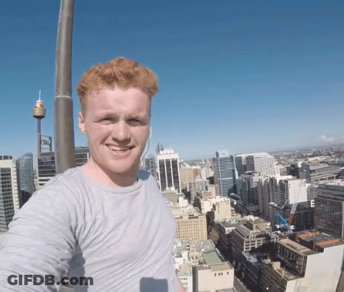 A Man Taking A Selfie In Front Of A City GIF