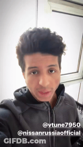A Man Taking A Selfie In Front Of A Window With The Hashtag @Vtune7950 GIF