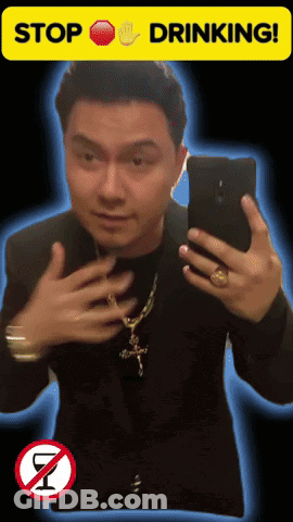 A Man Taking A Selfie With A Stop Drinking Sign GIF